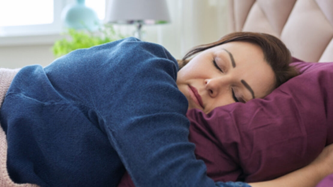 Woman resting on couch, demonstrating relaxation technique for sleep apnea management.