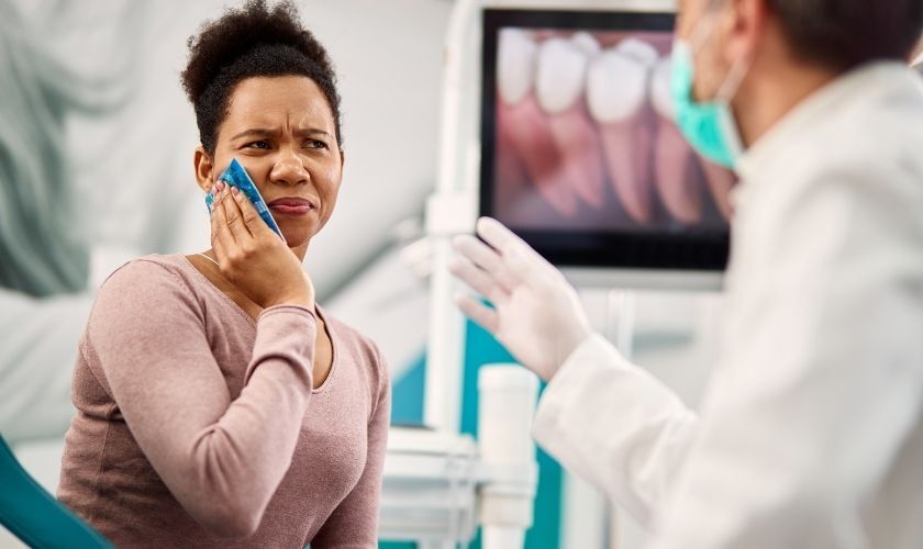 Patient experiencing tooth pain consulting with dentist in Snellville dental office.