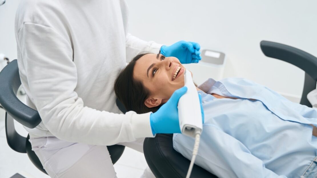 Dentist examining patient's teeth during full-mouth reconstruction consultation in Snellville.