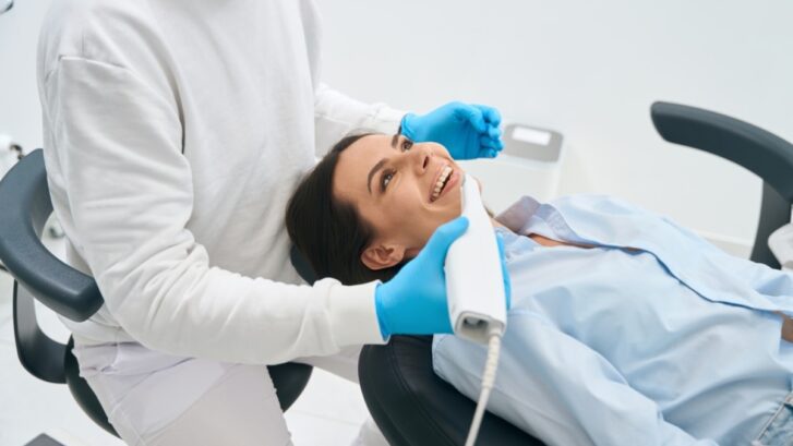 Dentist examining patient's teeth during full-mouth reconstruction consultation in Snellville.