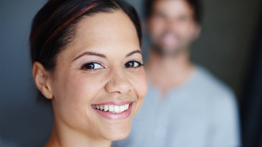 Woman with a bright, healthy smile in a dental office setting in Snellville, GA.