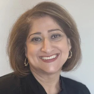 Professional headshot of smiling woman in dark blazer against neutral background for Brookwood Dentistry