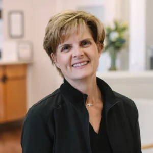 Ruth, dental hygienist at Snellville, GA practice, smiling in professional portrait.