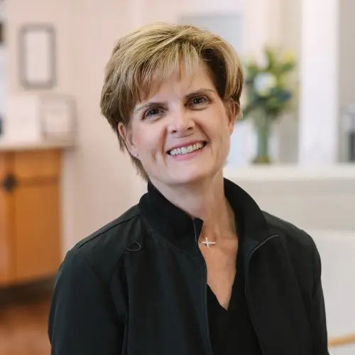 Ruth, dental hygienist at Snellville, GA practice, smiling in professional portrait.